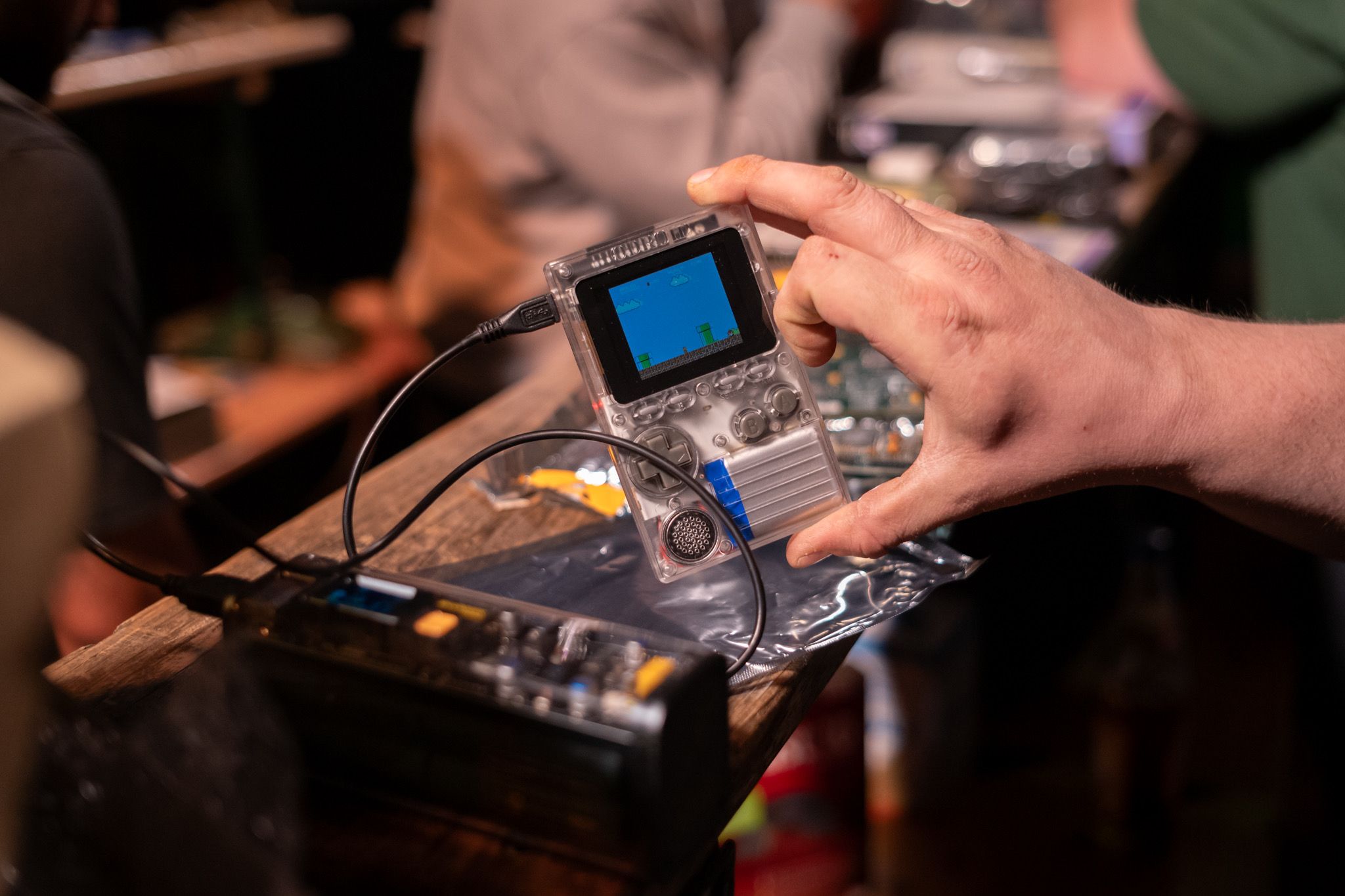 A close up on a DIY handheld game console in the shape of a GameBoy